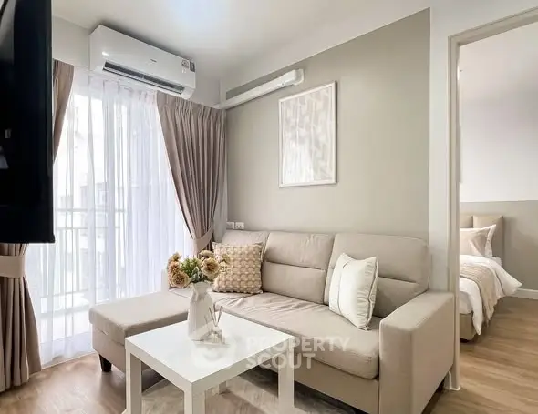 Chic modern living room with cozy beige sofa and elegant decor, perfect for urban living.