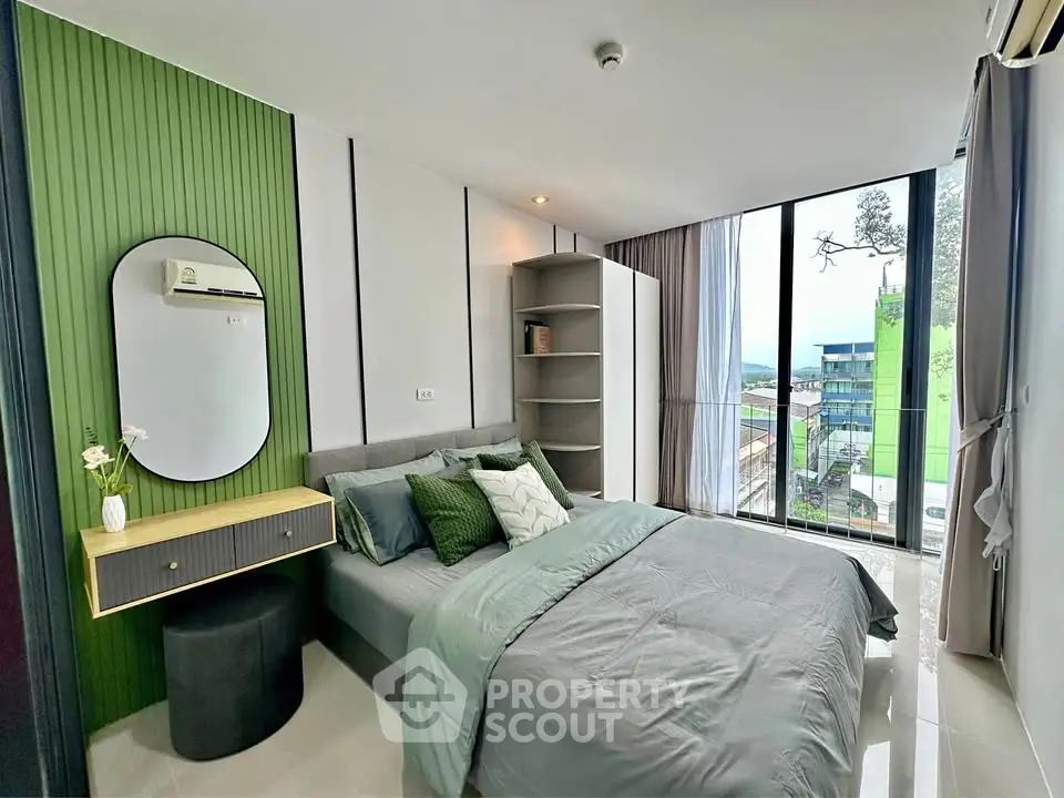 Modern bedroom with large windows and stylish decor, offering a serene view.