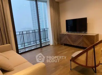 Modern living room with large window and stylish furniture in high-rise apartment.