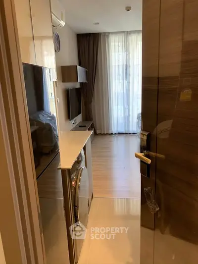 Modern apartment interior with washing machine and stylish living area