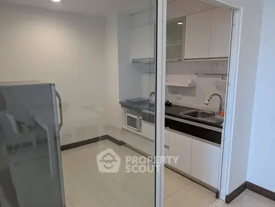 Modern kitchen with sleek cabinetry and built-in appliances in a compact layout.