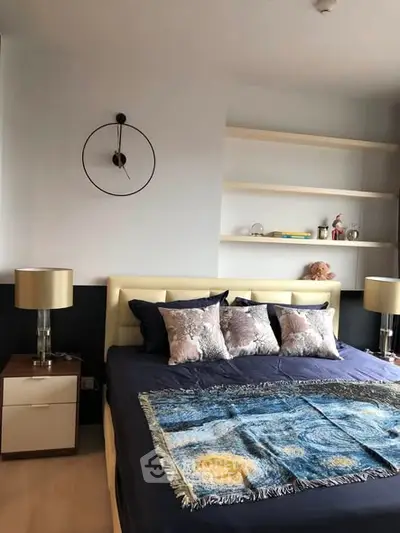 Stylish bedroom with modern decor and cozy bedding in a contemporary apartment.