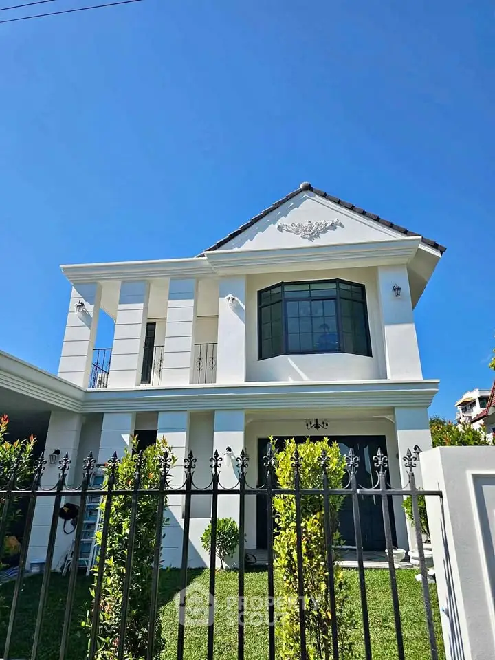 Elegant two-story house with modern facade and lush green lawn, perfect for family living.