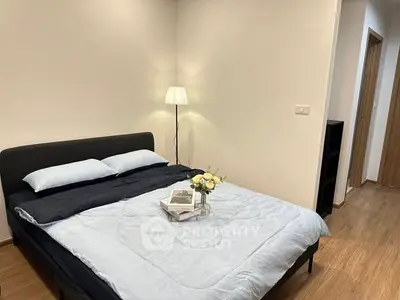 Cozy bedroom with modern decor and soft lighting, perfect for relaxation.