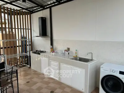 Modern outdoor kitchen with gas stove and washing machine