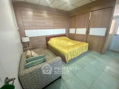 Spacious bedroom with modern design and cozy seating area