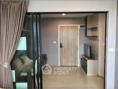 Modern apartment interior with sliding glass doors and cozy living area.