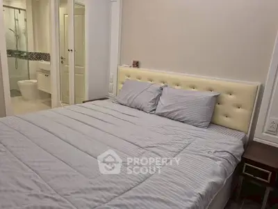 Cozy bedroom with modern ensuite bathroom in stylish apartment