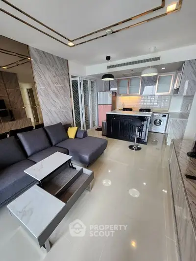 Modern open-layout living room with sleek kitchen and stylish furniture