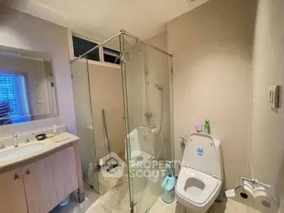 Modern bathroom with glass shower enclosure and sleek fixtures