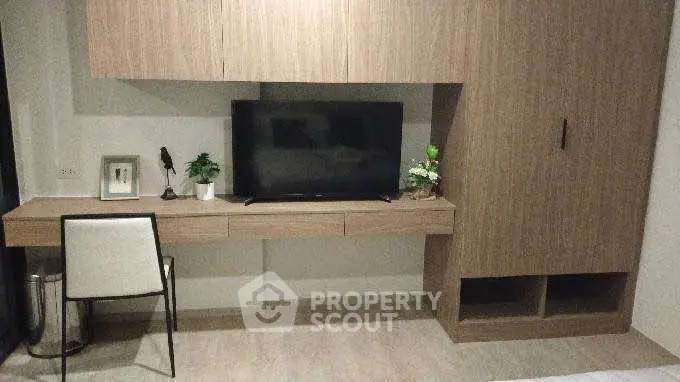 Modern living room with sleek wooden furniture and flat-screen TV, perfect for contemporary living.