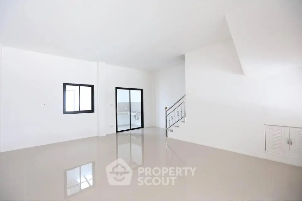 Spacious modern living room with sleek tile flooring and large windows