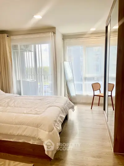 Bright modern bedroom with large windows and stylish decor