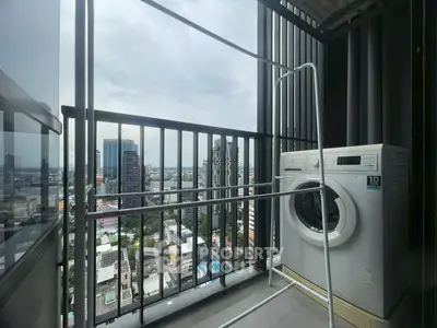 High-rise balcony with washing machine and city view, perfect for urban living.
