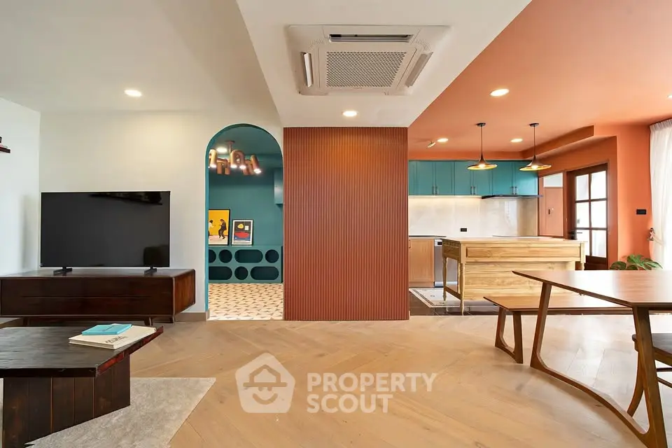 Modern open-plan living room with stylish kitchen and wooden flooring