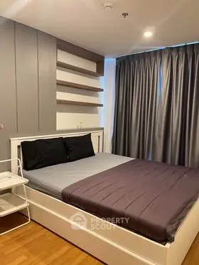 Modern bedroom with sleek design and cozy ambiance, featuring stylish shelving and elegant curtains.