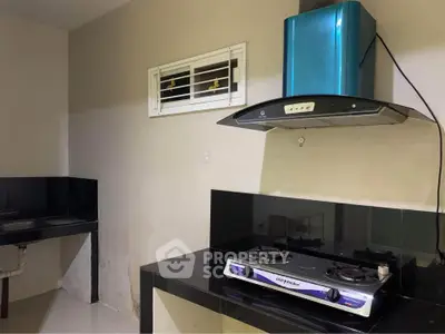 Modern kitchen with gas stove and sleek black countertops