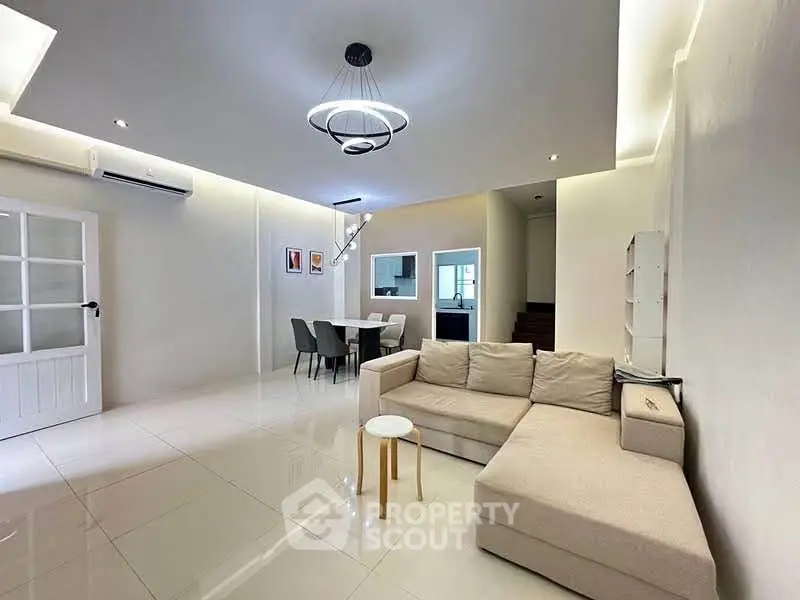 Spacious modern living room with elegant lighting and cozy seating area