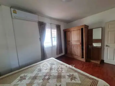 Cozy bedroom with wooden furniture and natural light