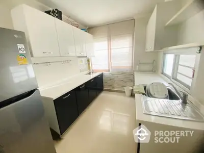 Modern kitchen with sleek cabinetry and ample natural light