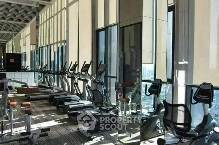Luxurious high-rise gym with panoramic city views and modern fitness equipment.