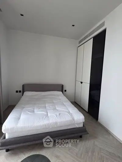 Modern minimalist bedroom with sleek wardrobe and cozy bed