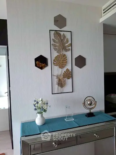 Stylish modern interior with decorative wall art and elegant console table in a chic living space.