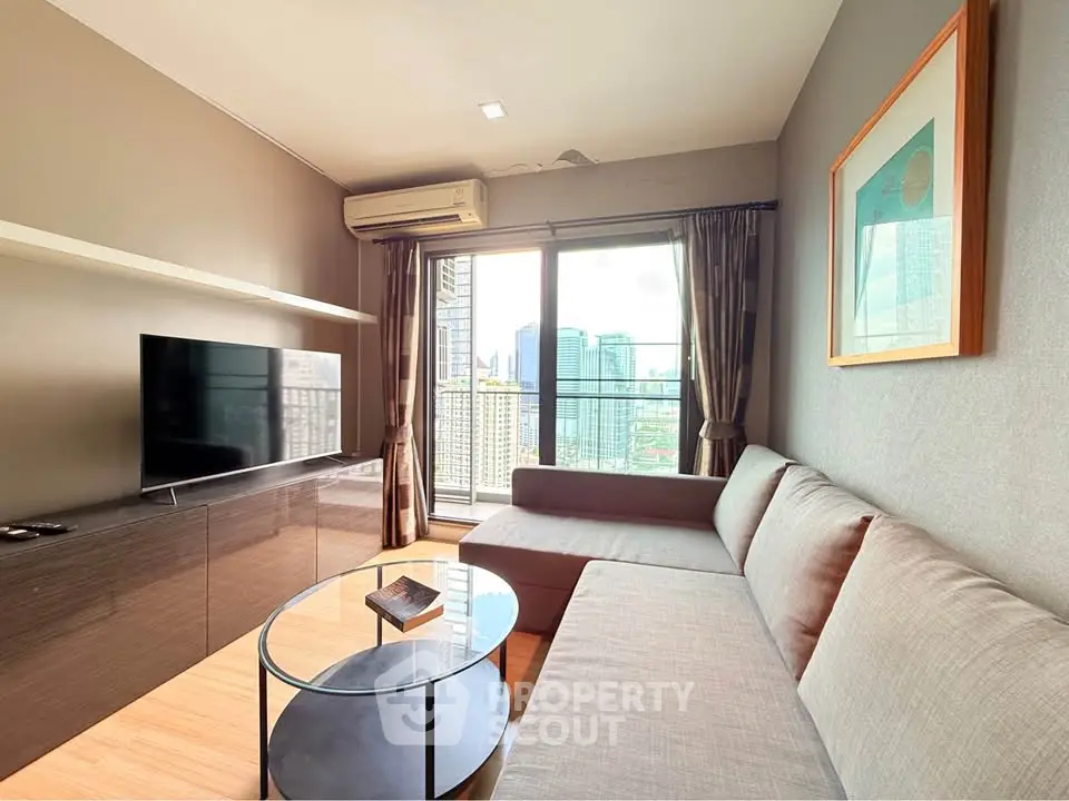 Modern living room with city view, featuring sleek furniture and large windows for natural light.