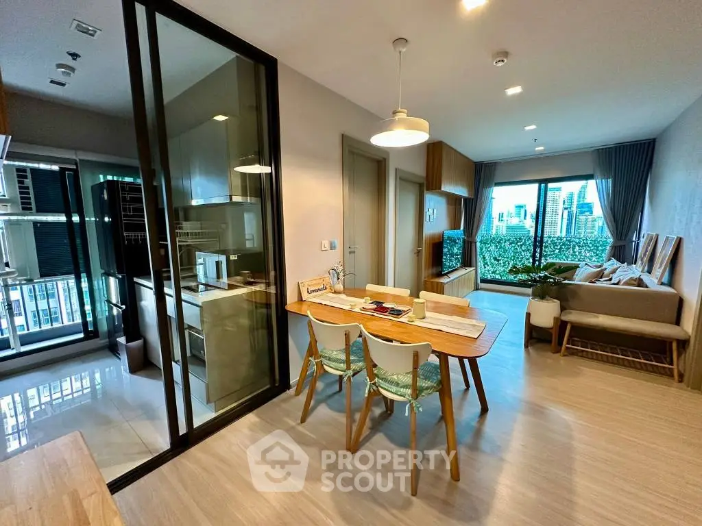 Modern open-plan living room with city view and stylish dining area.