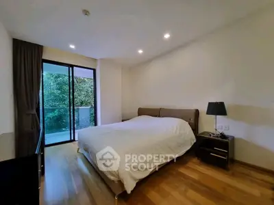 Spacious bedroom with modern decor and balcony view