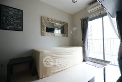 Cozy living room with modern decor and balcony access, featuring a stylish mirror and natural light.