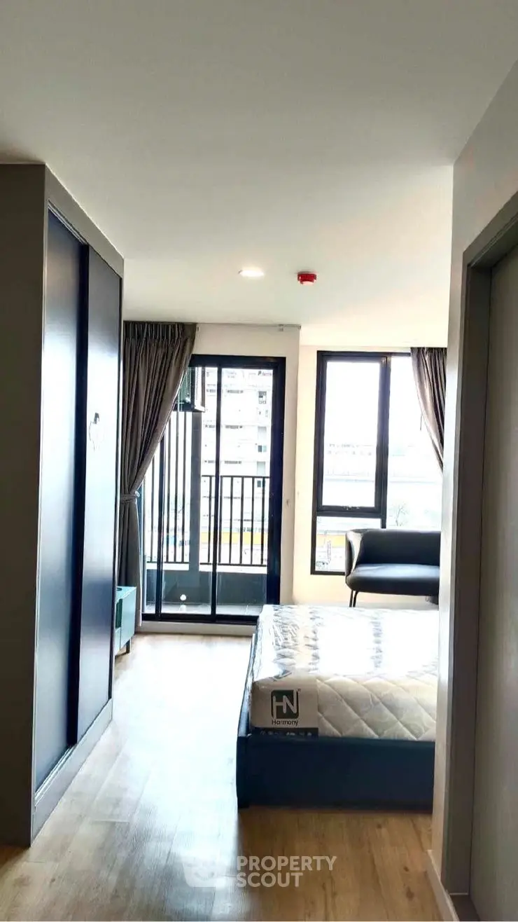 Modern bedroom with balcony view in urban apartment