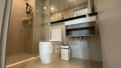 Modern bathroom with sleek fixtures and glass shower enclosure