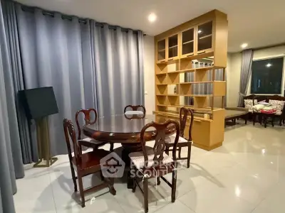 Elegant dining area with wooden furniture and built-in shelving in modern apartment