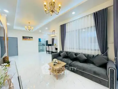 Luxurious living room with elegant decor and spacious layout, featuring a plush sofa and modern lighting.