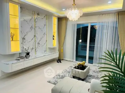 Luxurious living room with elegant marble wall and chandelier lighting.