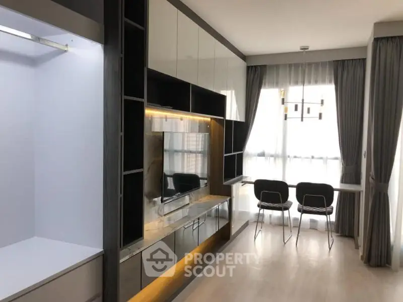 Modern living room with sleek built-in storage and large windows for natural light.