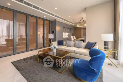 Luxurious modern living room with elegant furniture and open kitchen layout, perfect for stylish urban living.