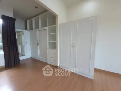 Spacious bedroom with elegant built-in wardrobes and large mirror