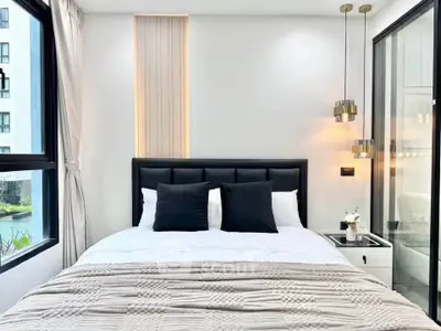 Modern bedroom with stylish lighting and large windows in a luxury apartment.