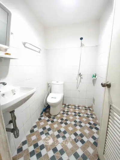 Compact bathroom with modern fixtures and stylish tile flooring
