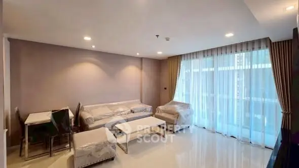 Spacious modern living room with elegant furniture and large windows for natural light.