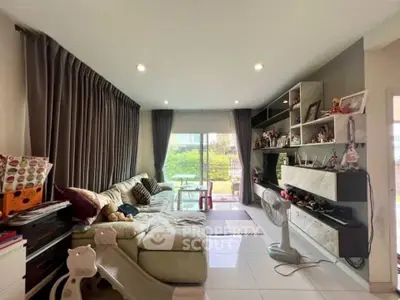 Spacious living room with modern decor and large windows for natural light.