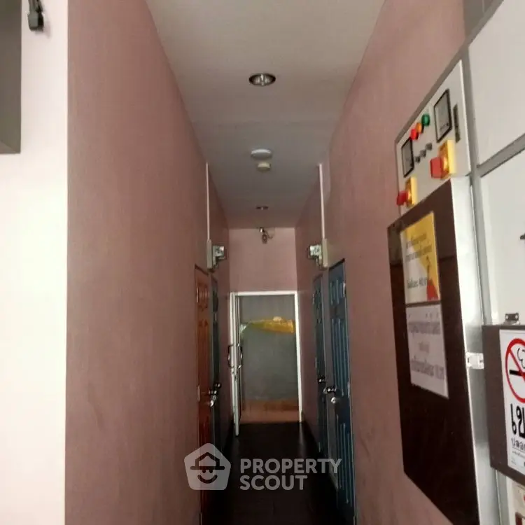 Narrow corridor with multiple doors in a residential building