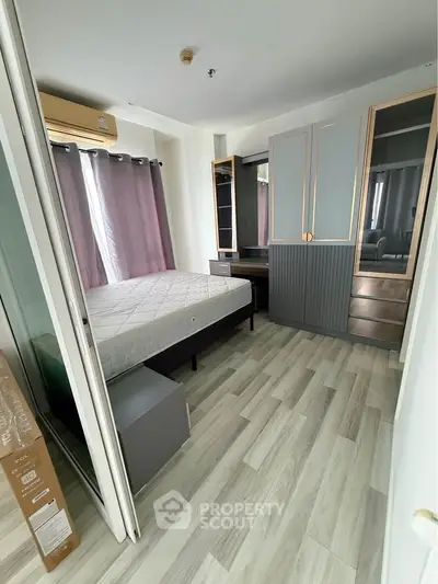 Modern bedroom with stylish wardrobe and natural light, perfect for comfortable living.