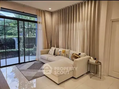 Elegant living room with large windows and cozy sectional sofa