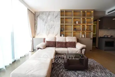Luxurious living room with modern sofa and stylish shelving in a contemporary apartment.