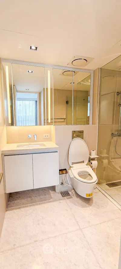 Modern bathroom with sleek fixtures and glass shower enclosure