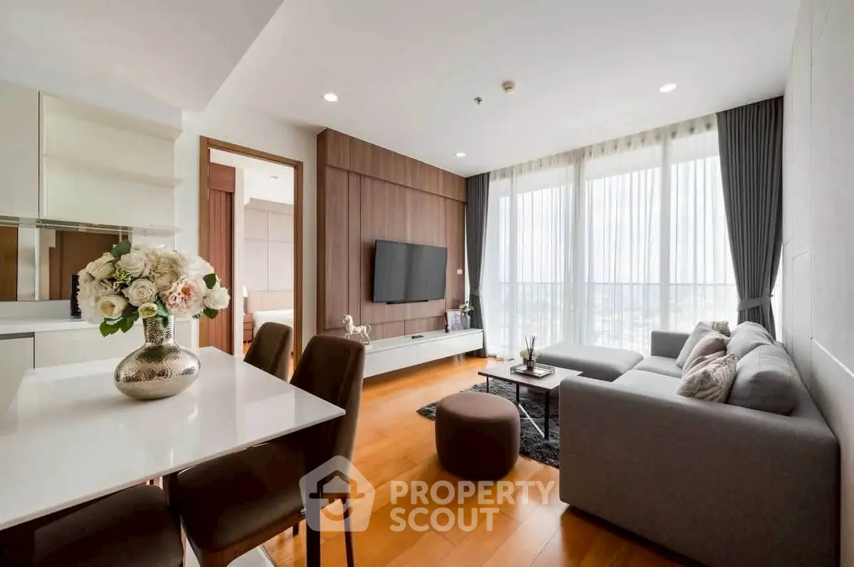 Modern living room with elegant decor and large windows offering a stunning view.