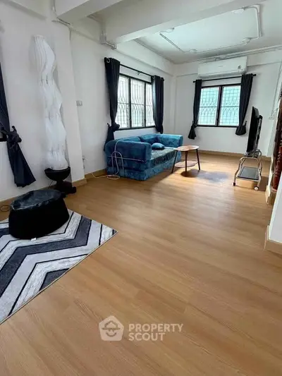 Spacious living room with modern decor and natural light